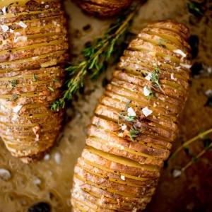 Patate Hasselback all'Aglio 20 patate hasselback al burro e aglio guarnite con timo fresco e sale in fiocchi
