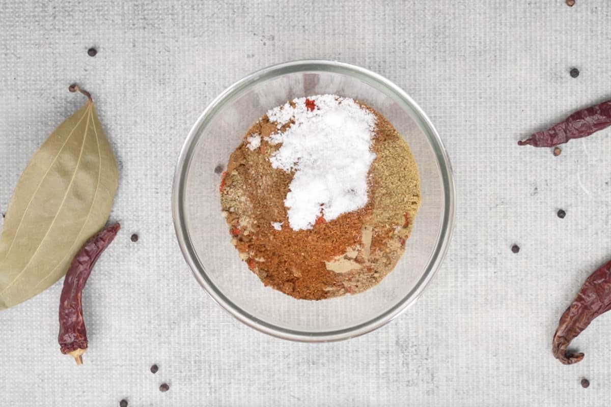 Rogan Josh di Montone 4 Yogurt e spezie in polvere aggiunti in una ciotola.
