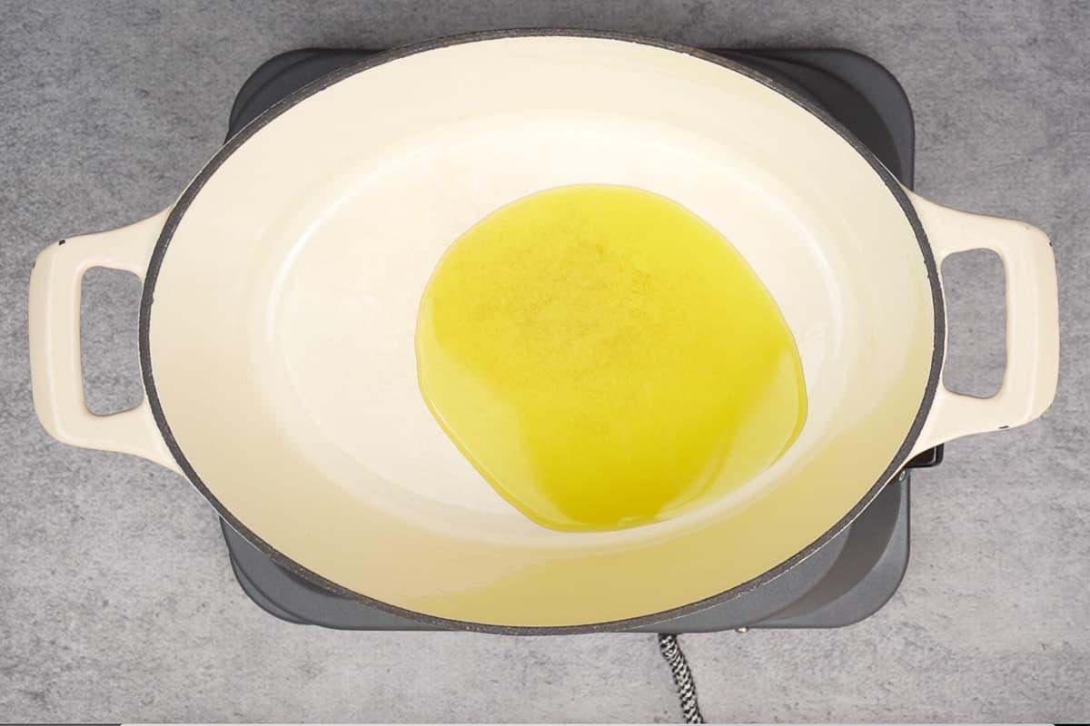 Remaining olive oil heating in a pot.