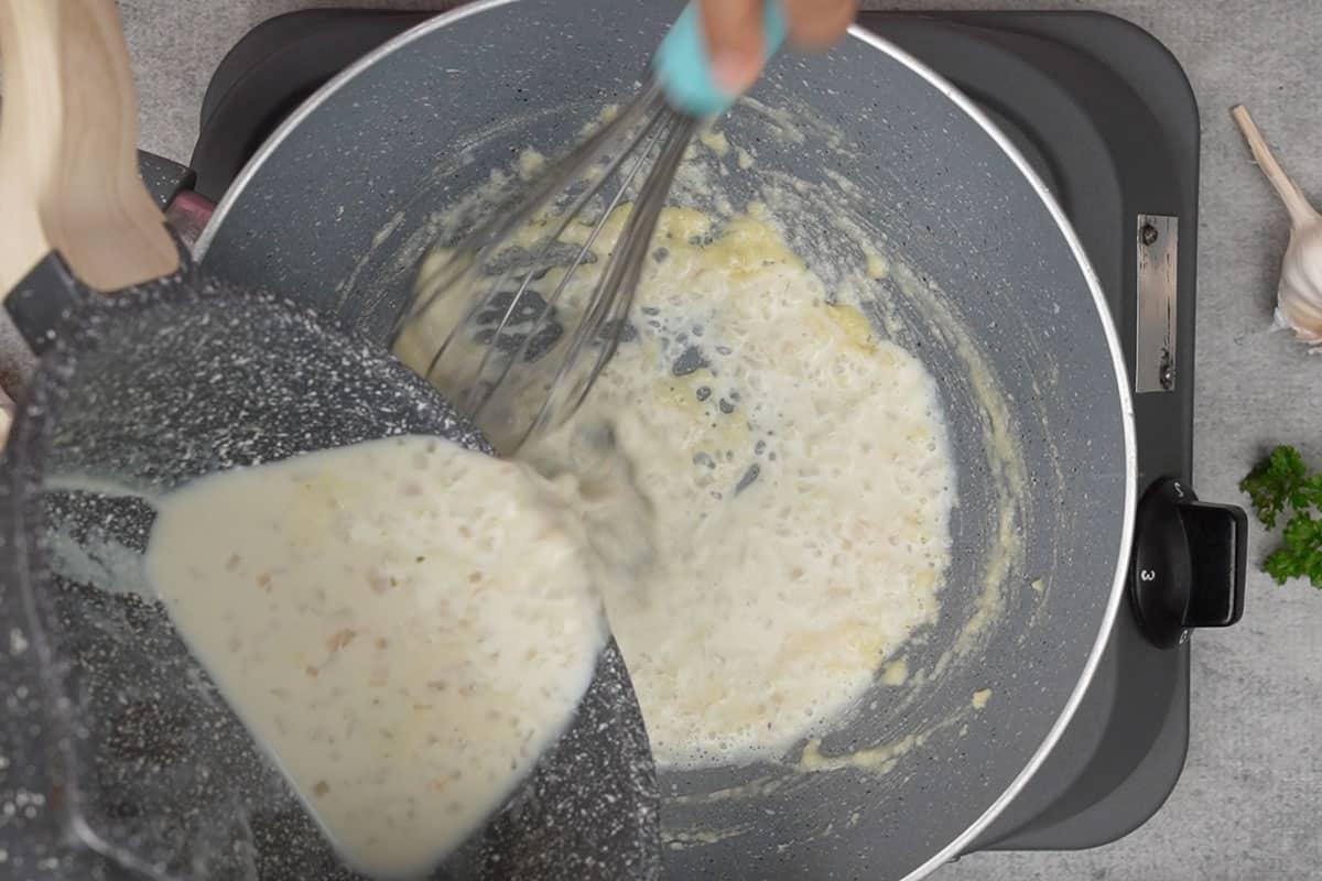 Salsa al Limone, Aglio e Burro 9 Miscela di brodo di pollo versata nella padella con il roux.