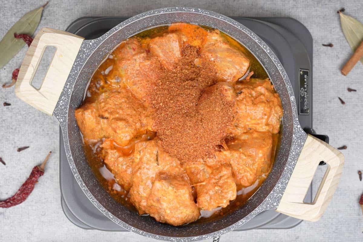 Pollo Angara 11 marinated chicken and spice powder added to the pan.