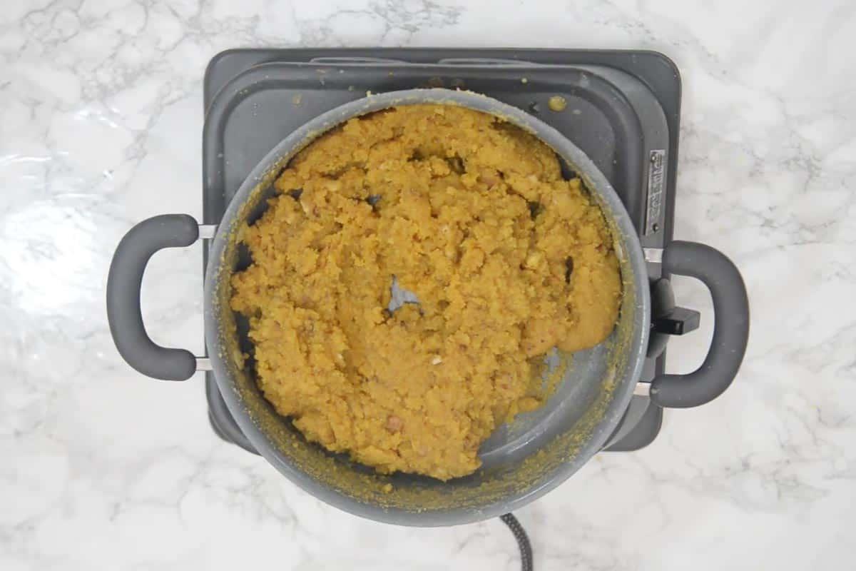 Halwa di Moong Dal 13 Moong Dal Halwa pronto, di colore marrone intenso, con il ghee che si separa e lo rende lucido.