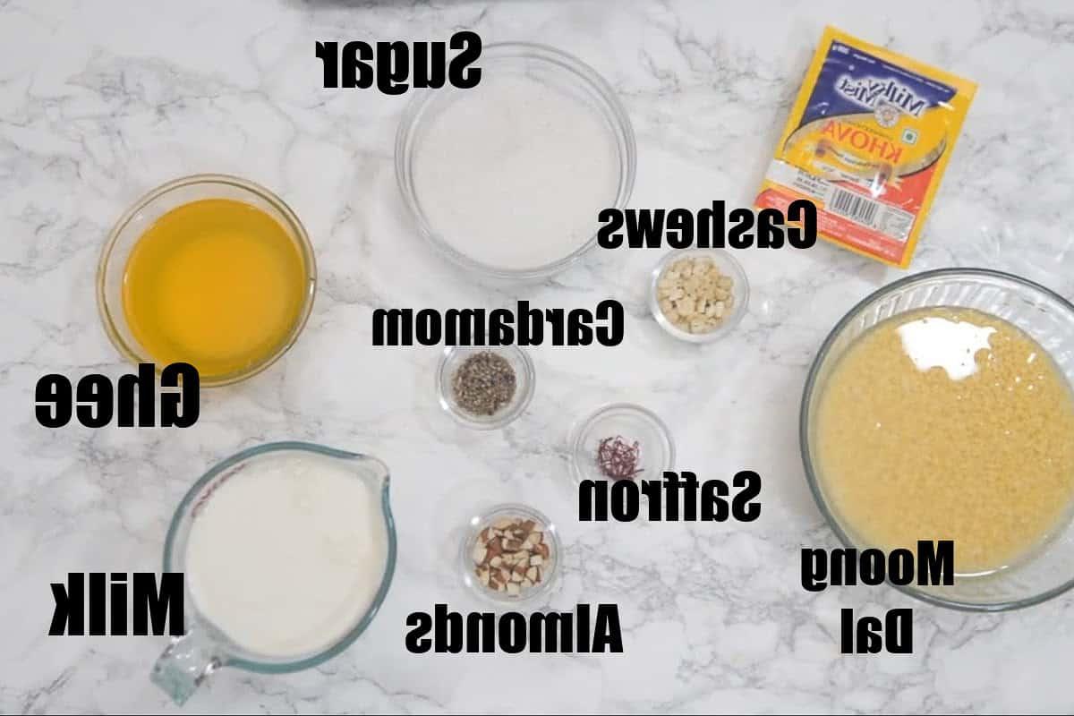 Halwa di Moong Dal 3 Ingredienti per Moong Dal Halwa: un assortimento di lenticchie mung, ghee, latte, khoya, zucchero, cardamomo, zafferano, mandorle e anacardi.