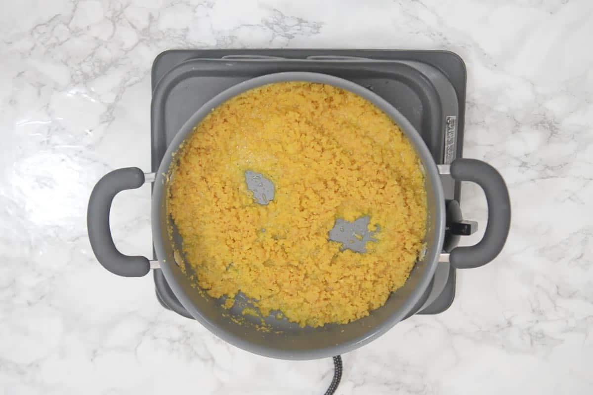 Halwa di Moong Dal 8 Pasta di lenticchie fritta fino a doratura, con una consistenza granulare e separata, pronta per il passo successivo.