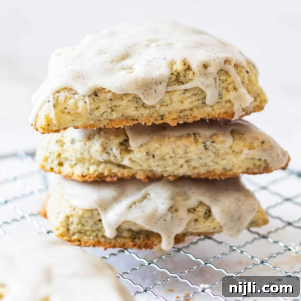 Aromatic Earl Grey Scones with Vanilla Bean Glaze 3 earl grey scones stacked on a wire rack