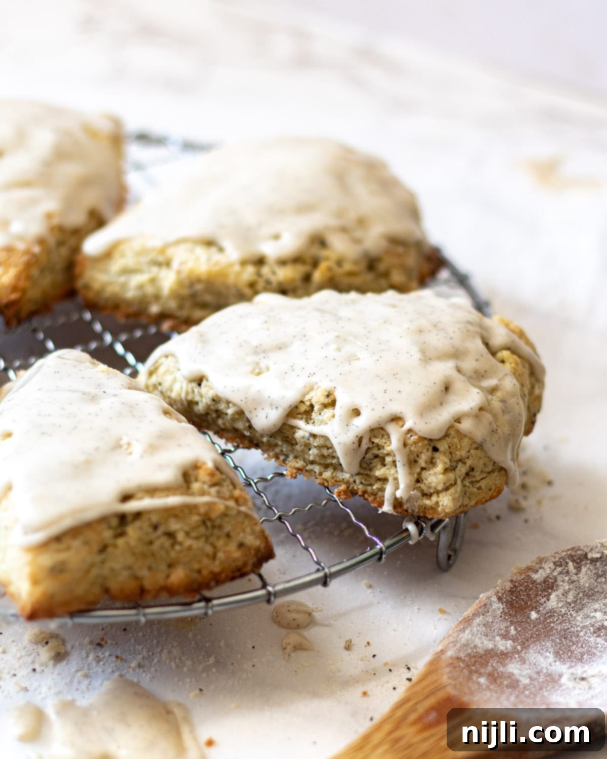 Earl Grey Scones on a wire rack drizzled with vanilla bean glaze