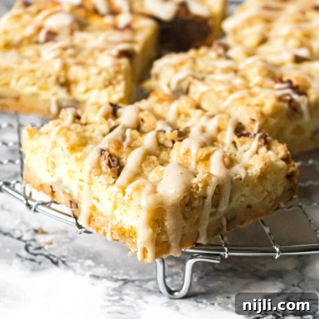 Close up of pineapple bars with a sweet coconut drizzle, ready to be served.