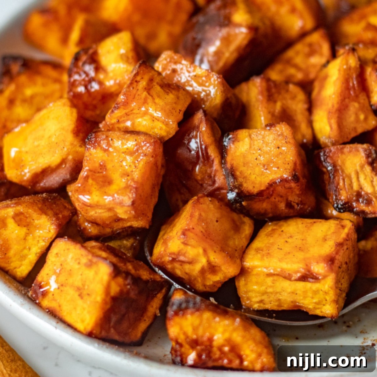 Crispy Air Fryer Sweet Potato Chunks 2 Close-up of golden brown crispy air fryer sweet potato cubes seasoned with cinnamon and brown sugar