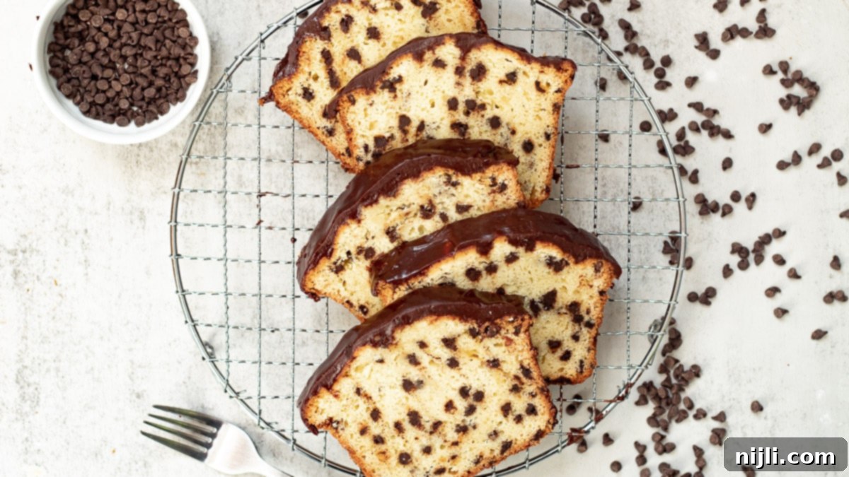 slices of chocolate chip loaf cake on a tray with a microwave in the background, illustrating the butter softening tip.