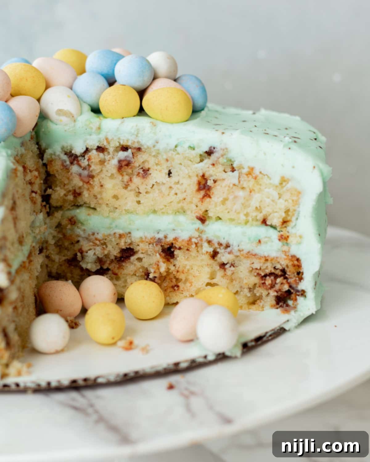 cut mini eggs cake on a cake stand