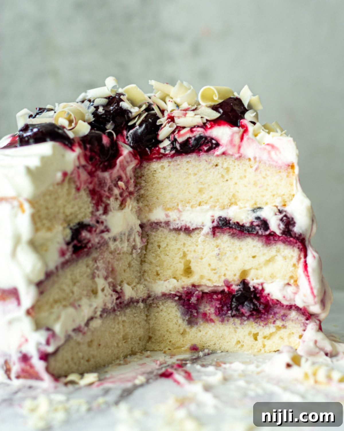 Snow-Kissed Forest Cake 7 A stunning cross-section of a homemade White Forest Cake, showing the beautiful layers, ready to be enjoyed.