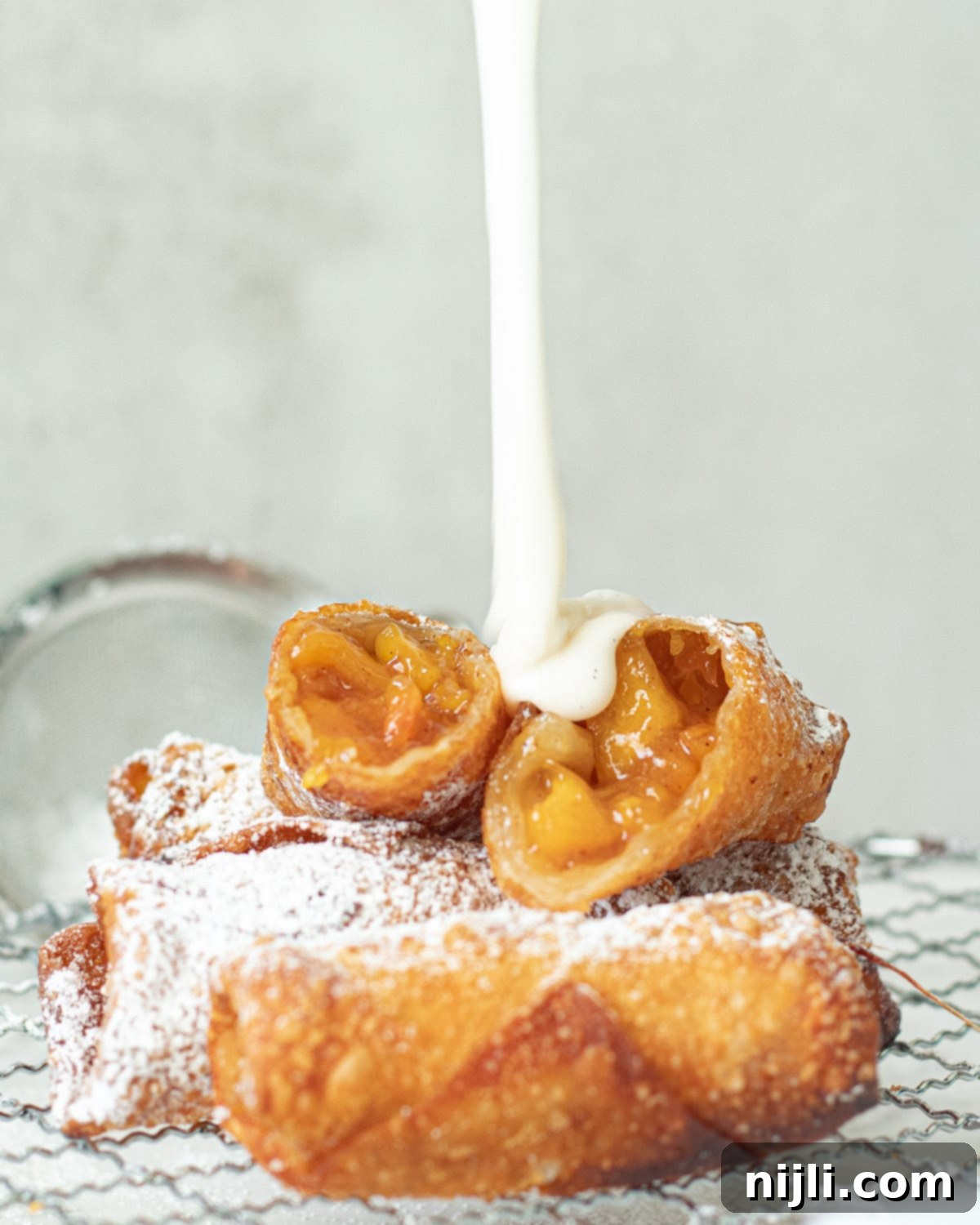 Peach Cobbler Egg Rolls 4 vanilla icing on peach egg rolls