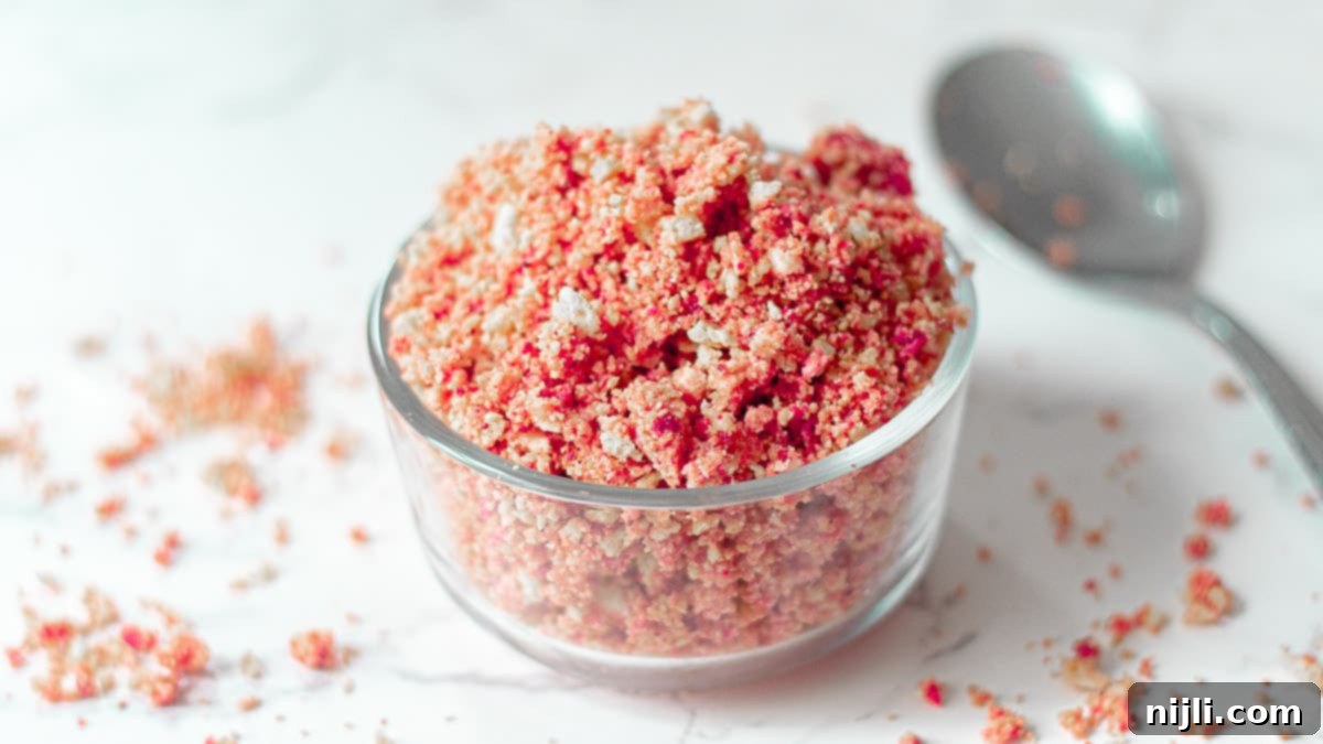 Classic Strawberry Shortcake Crumble 5 A bowl full of freshly made strawberry crunch topping, with visible pieces of freeze-dried strawberries and crushed golden cookies, ready to be sprinkled on desserts.