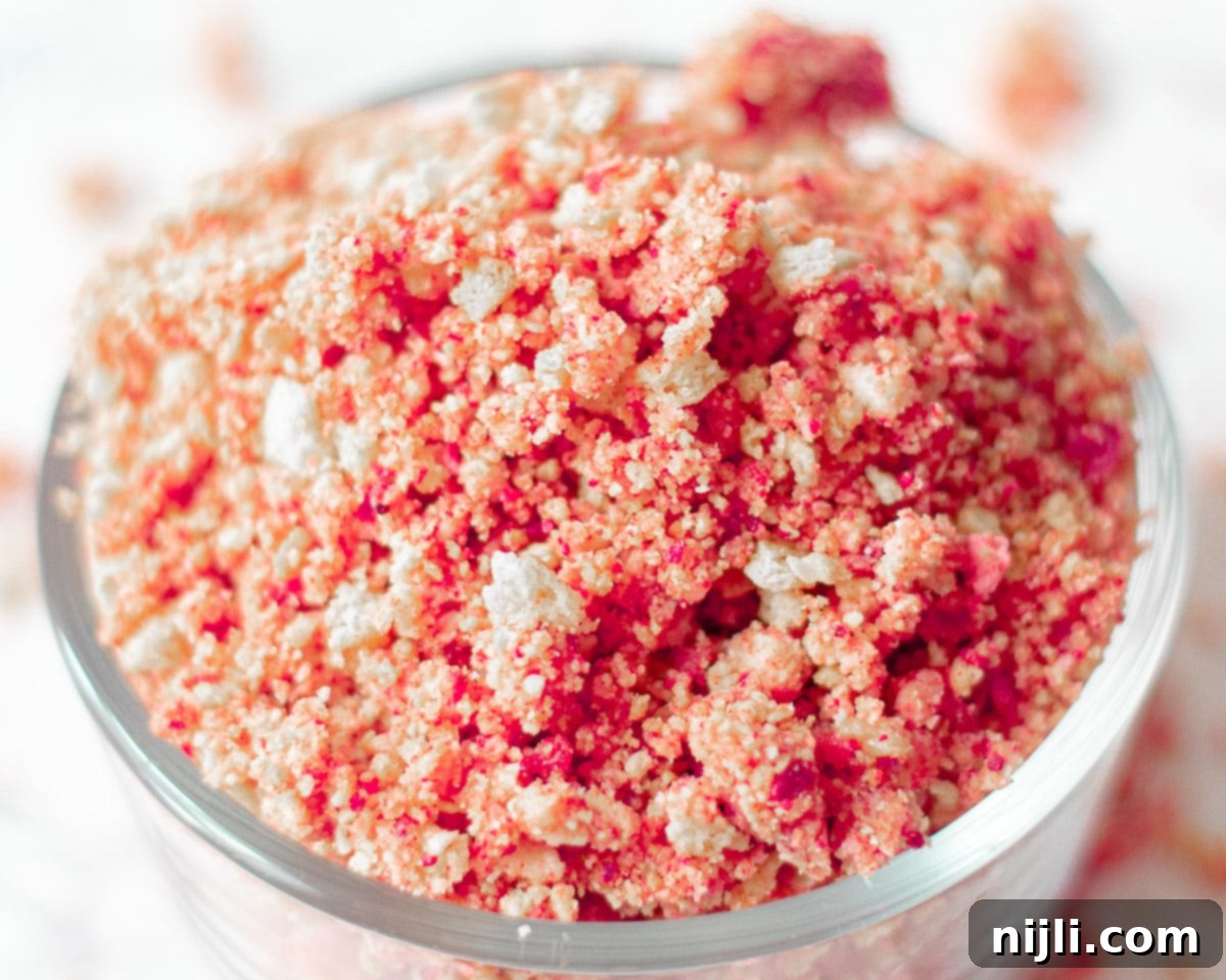 Classic Strawberry Shortcake Crumble 6 A close-up view of the textured and colorful strawberry crunch topping, showcasing the crispy bits of freeze-dried strawberries and perfectly crushed golden cookies.