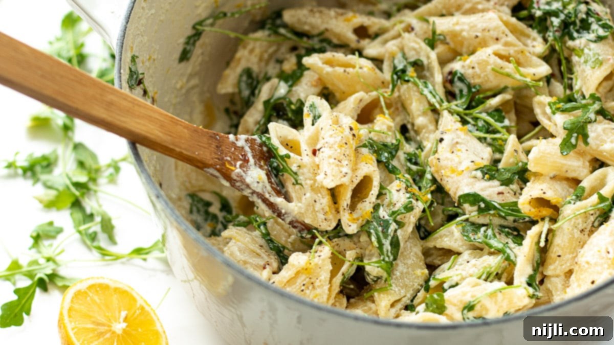 Vibrant Lemon Ricotta Pasta 3 ricotta lemon pasta in a pot with a spoon