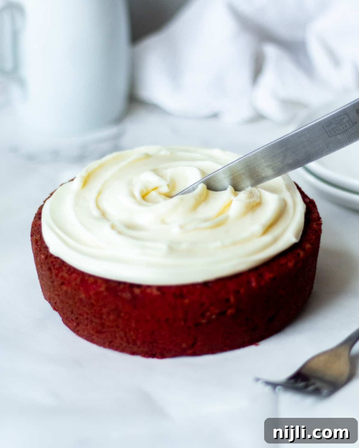 Petite Red Velvet Delights 9 knife cutting into mini red velvet cake