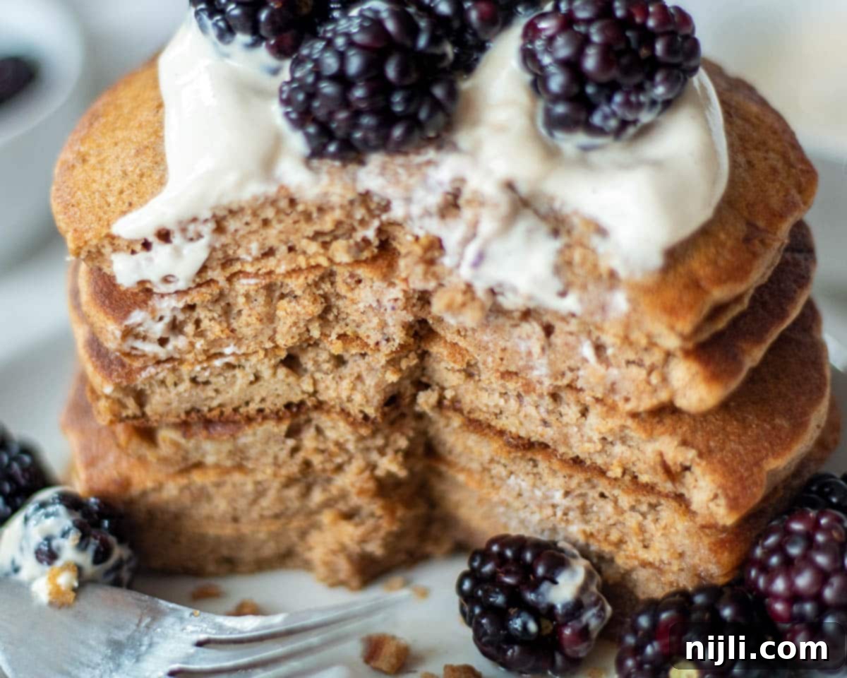 Fluffy Oat Milk Bliss 5 Close-up view of stacked oat milk pancakes, highlighting their fluffy texture.