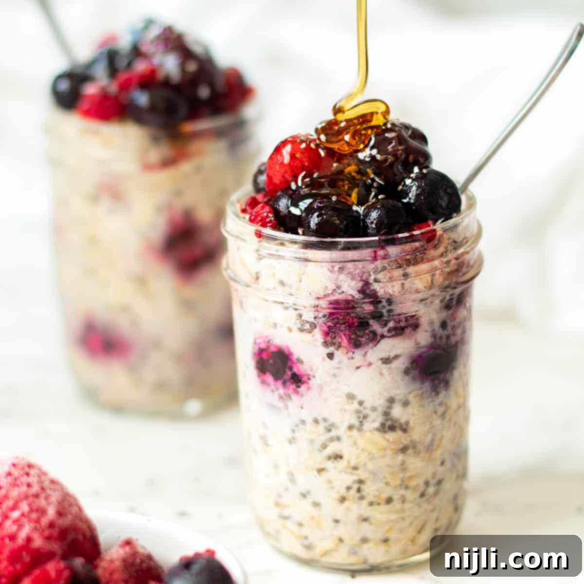 Cool & Creamy Fruit Overnight Oats 2 overnight oats with frozen fruit in mason jars