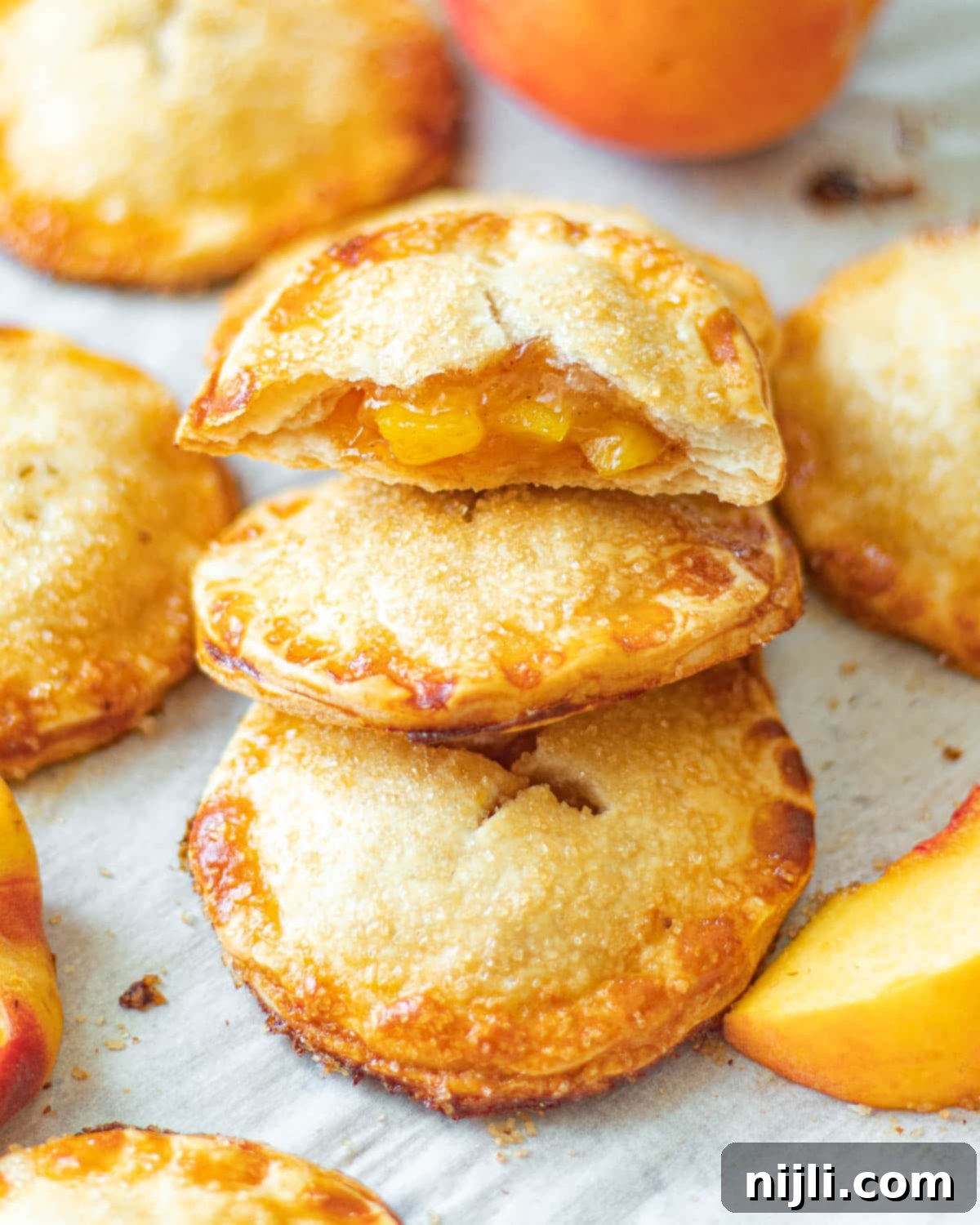 Tropical Peach Mango Pie 5 peach mango pie (jollibee recipe copycat) on a tray with a bite taken out