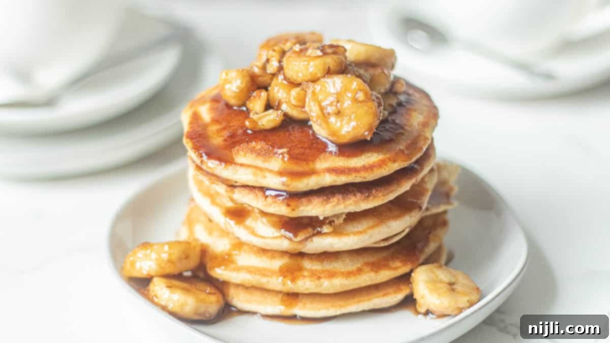 bananas foster pancakes recipe stacked on a plate