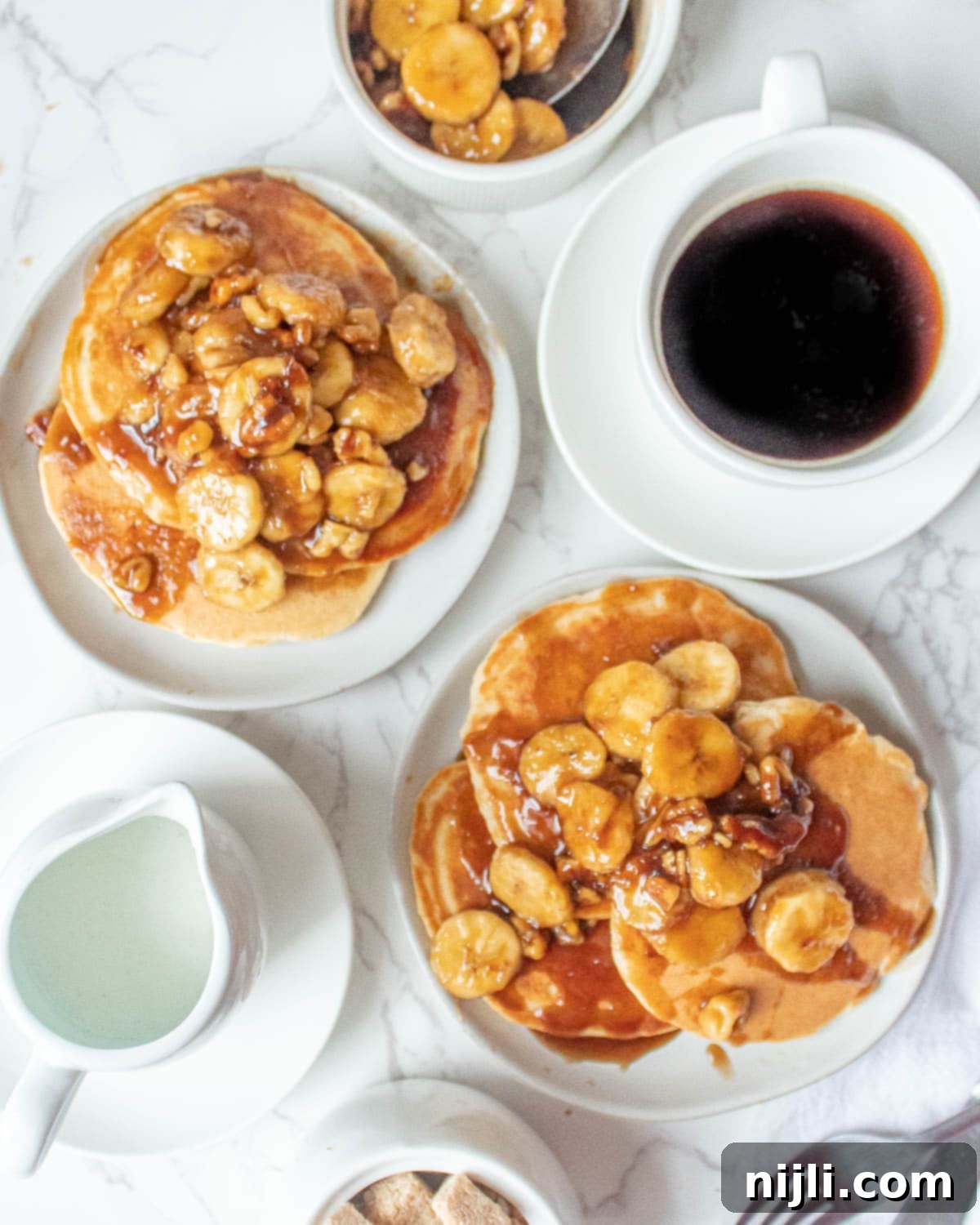 banana foster pancakes without alcohol stacked on a plate