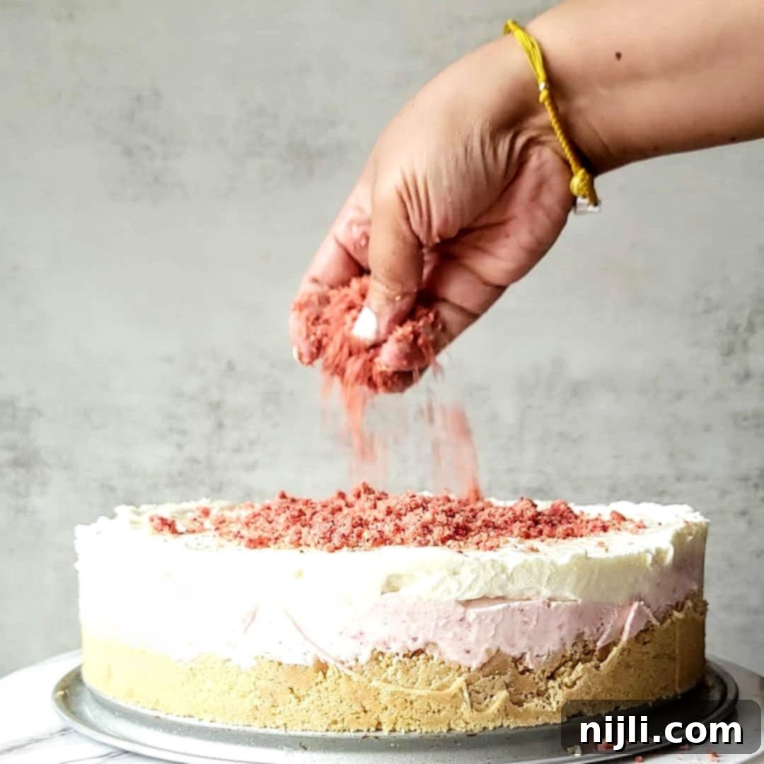 Strawberry Crunch Cheesecake 11 Generously sprinkling strawberry crunch topping over the creamy layers of a no-bake cheesecake.