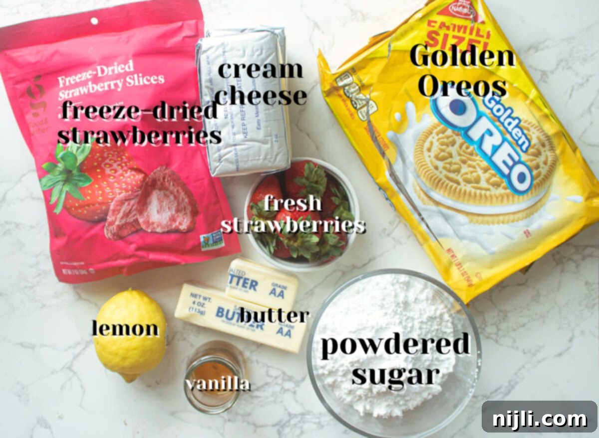 Strawberry Crunch Cheesecake 3 A flat lay of all the fresh ingredients needed for a strawberry crunch cheesecake: Golden Oreos, fresh strawberries, cream cheese, butter, and more.