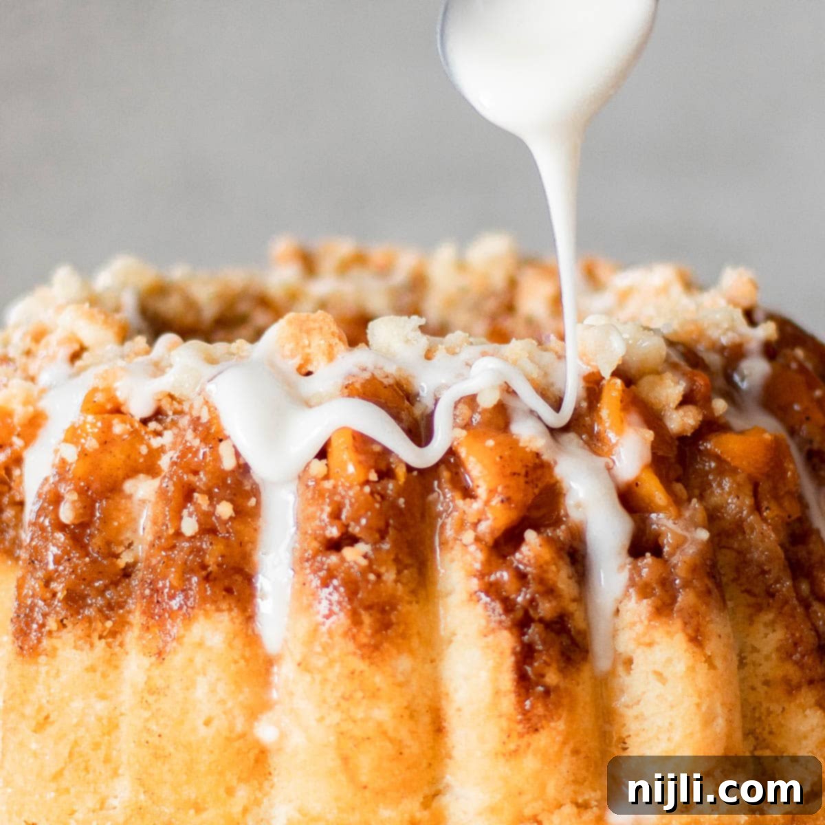 Southern Peach Pound Cake 2 drizzing icing on peach cobbler pound cake with canned peaches recipe