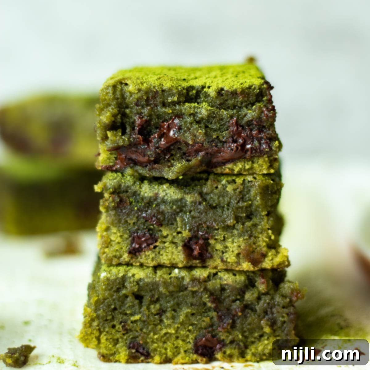 Green Tea Dream Brownies 2 Stacked fudgy matcha brownies with a hint of green and chocolate chunks