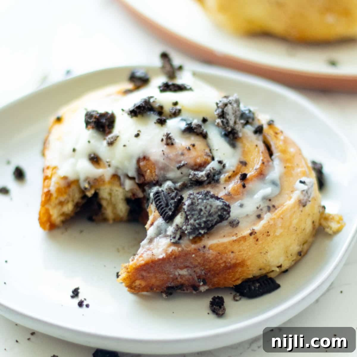 oreo cinnamon rolls on plates with a bite taken out