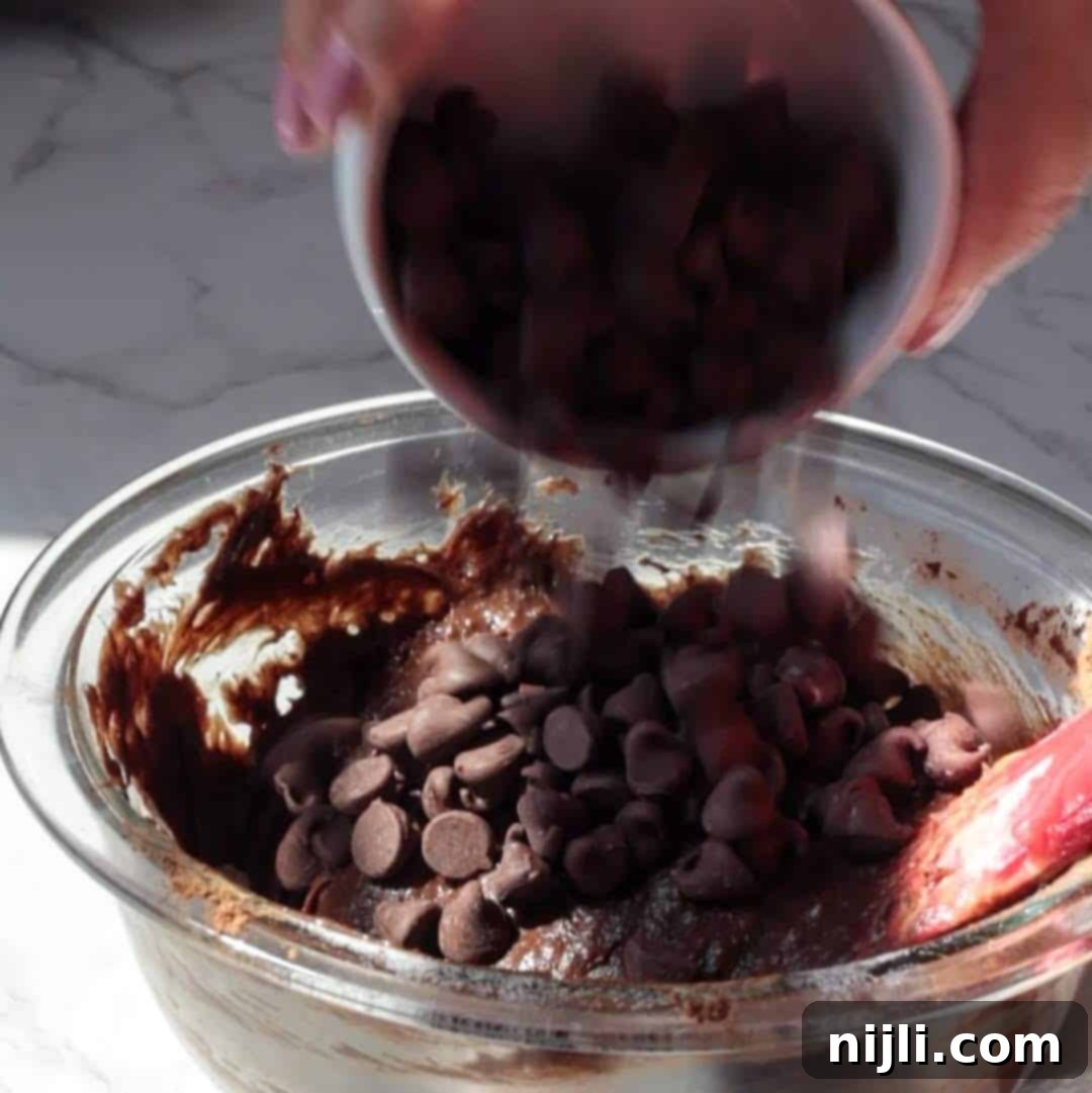 Step 3: Adding chocolate chips and cocoa powder to batter bowls.