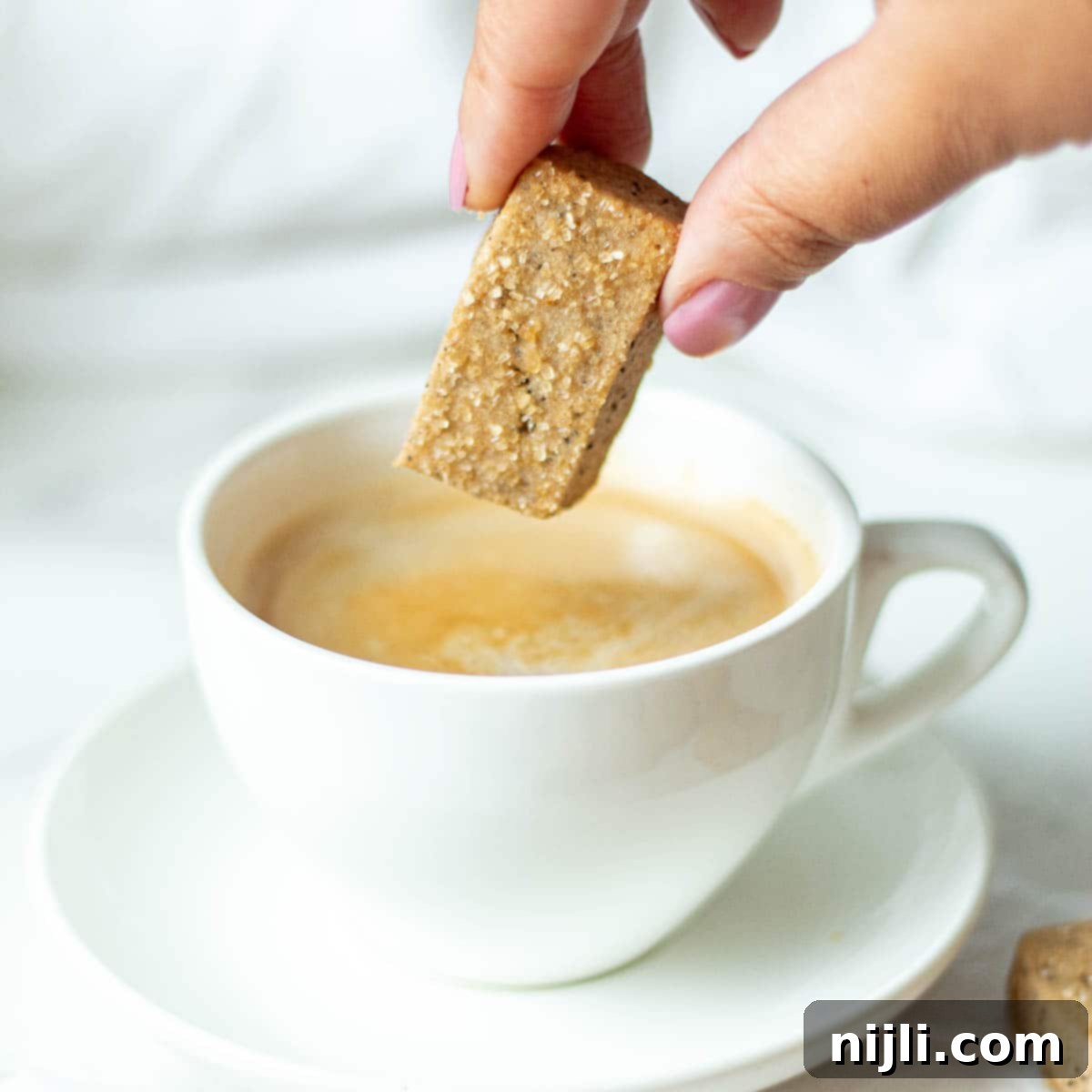 Espresso Bites 2 dipping coffee cookies in coffee