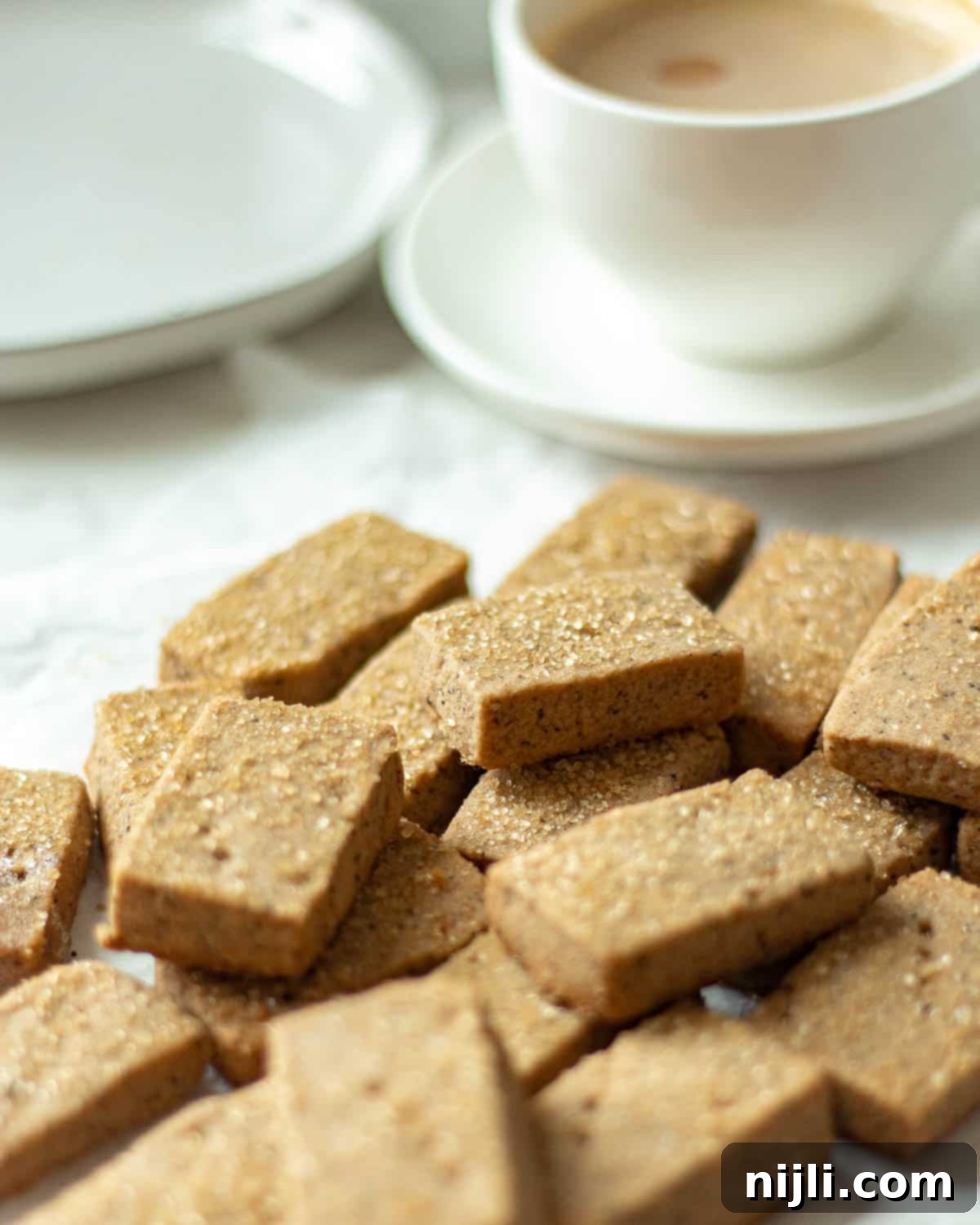 Espresso Bites 12 coffee cookies next to a mug of coffee