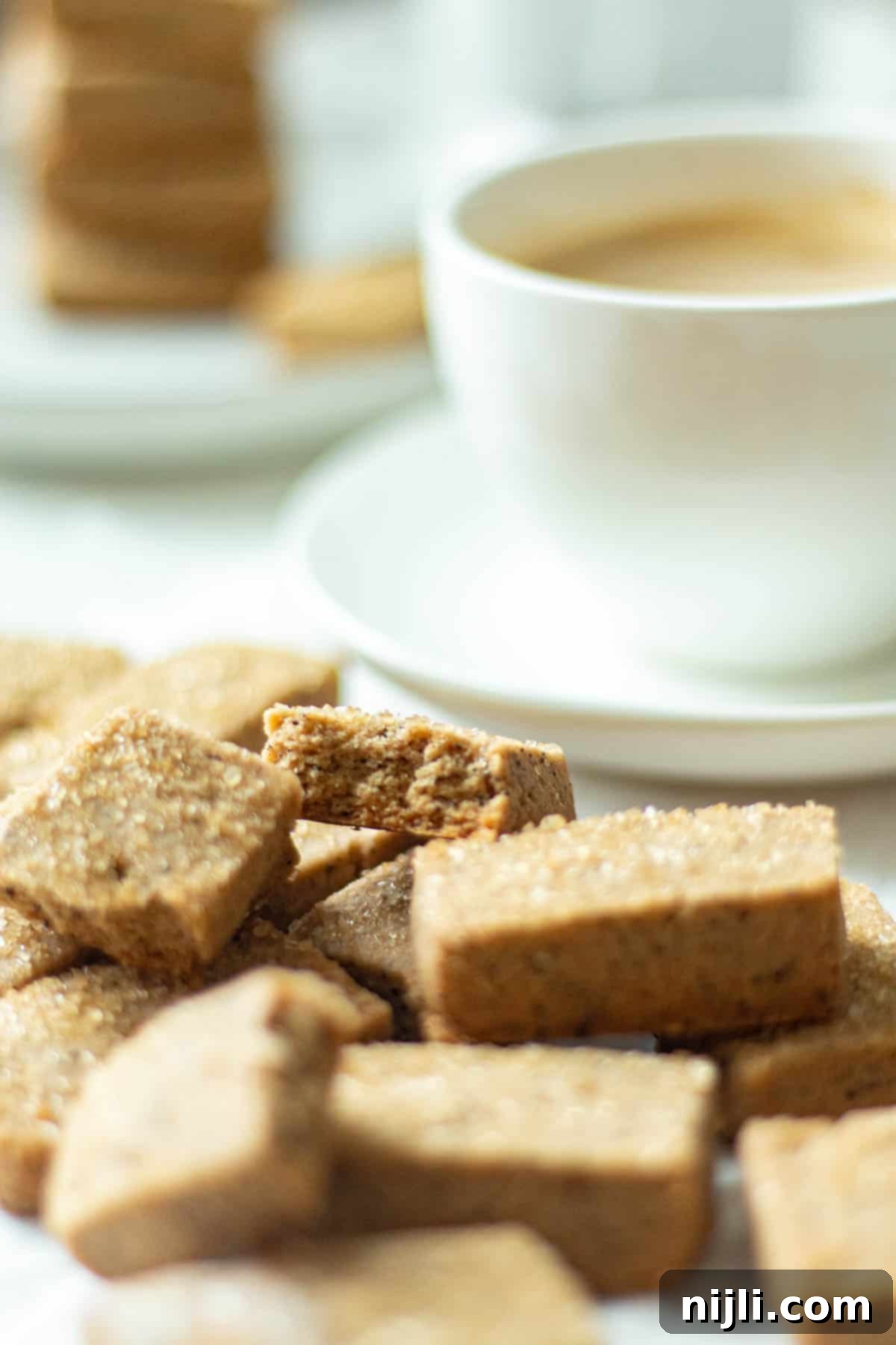 Espresso Bites 3 brown sugar coffee cookies next to a coffee mug