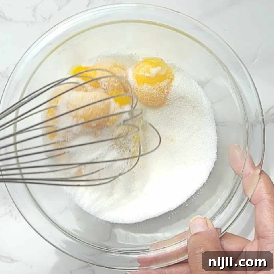 Spiced Oat Milk Cheer 6 Step 1: Whisking egg yolks and sugar together in a small bowl until smooth.