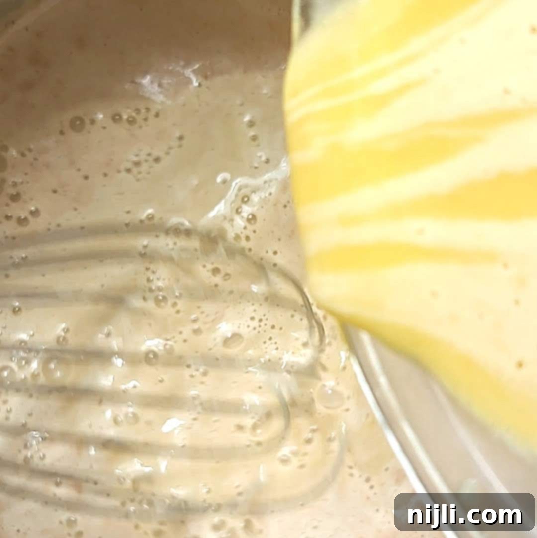 Spiced Oat Milk Cheer 10 Step 5: Pouring tempered egg mixture back into the saucepan with the remaining oat milk and whisking to thicken.