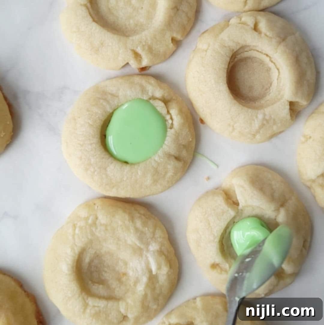 Iced Thumbprint Cookies 8 thumbprint cookies with icing step 4
