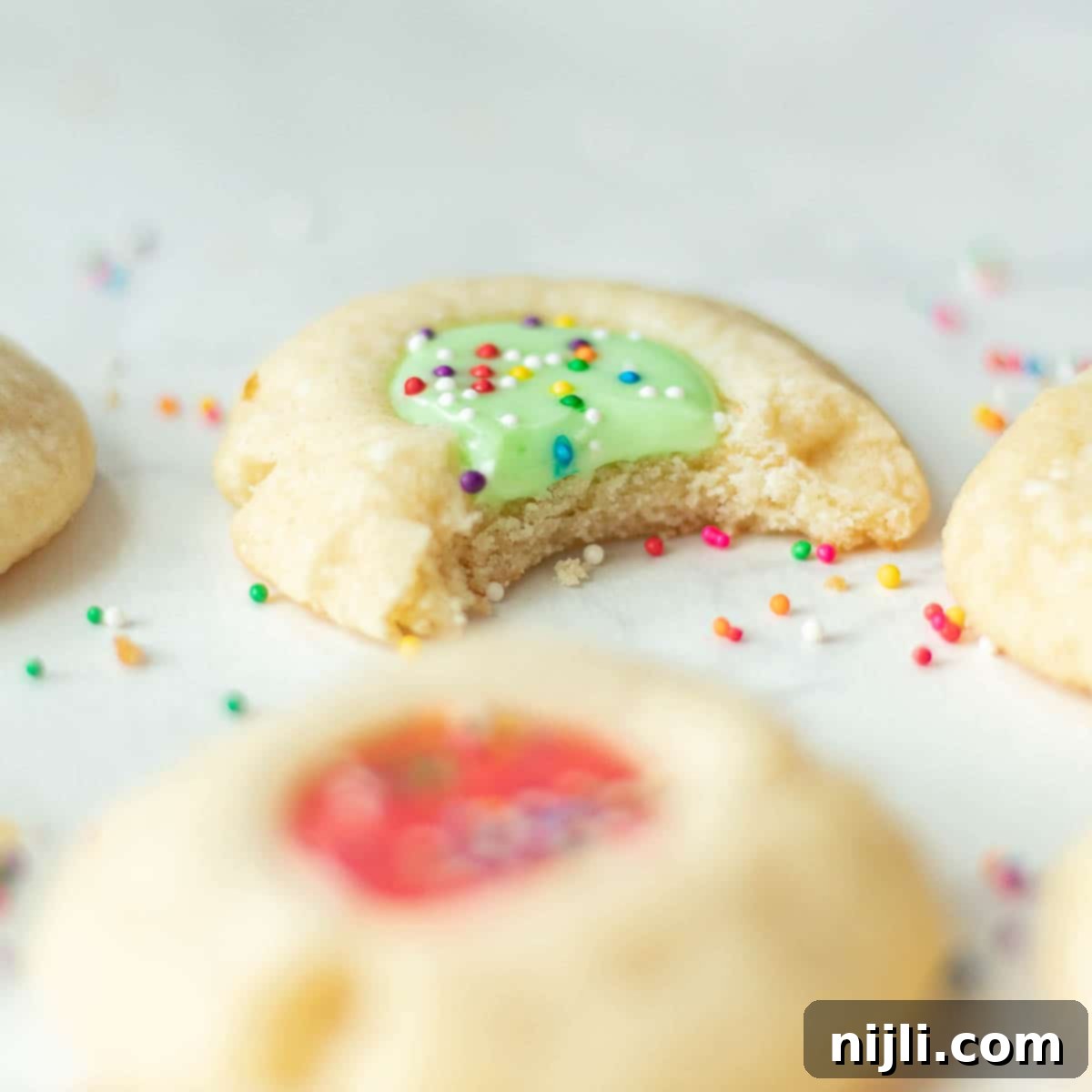 Iced Thumbprint Cookies 9 almond thumbprint cookies with icing