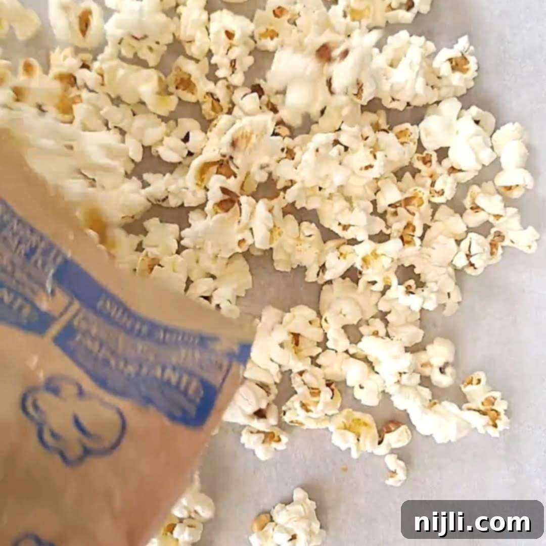 Step 1: Spreading popped popcorn on parchment paper