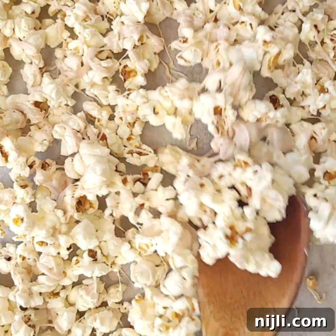 Step 3: Drizzling the cinnamon-white chocolate mixture over popcorn