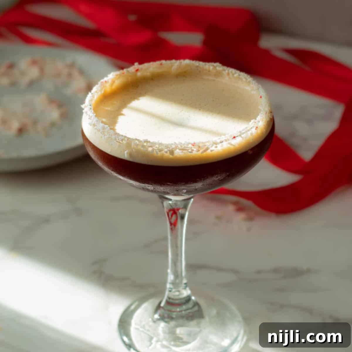 Peppermint Buzz Martini 2 peppermint espresso martini with peppermint candy on the rim