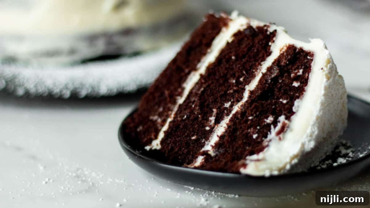 Decadent Chocolate Cake with Velvety Cream Cheese Frosting 6 chocolate cake with cream cheese filling on a plate