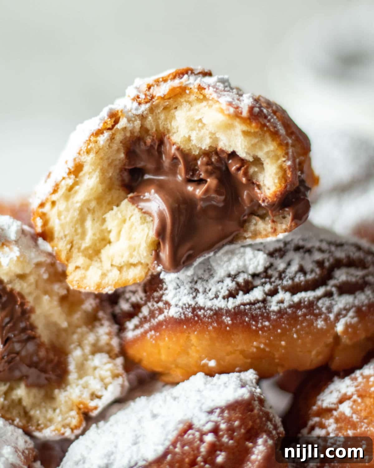 Decadent Chocolate Beignets 15 freshly fried chocolate beignets, piled high with powdered sugar