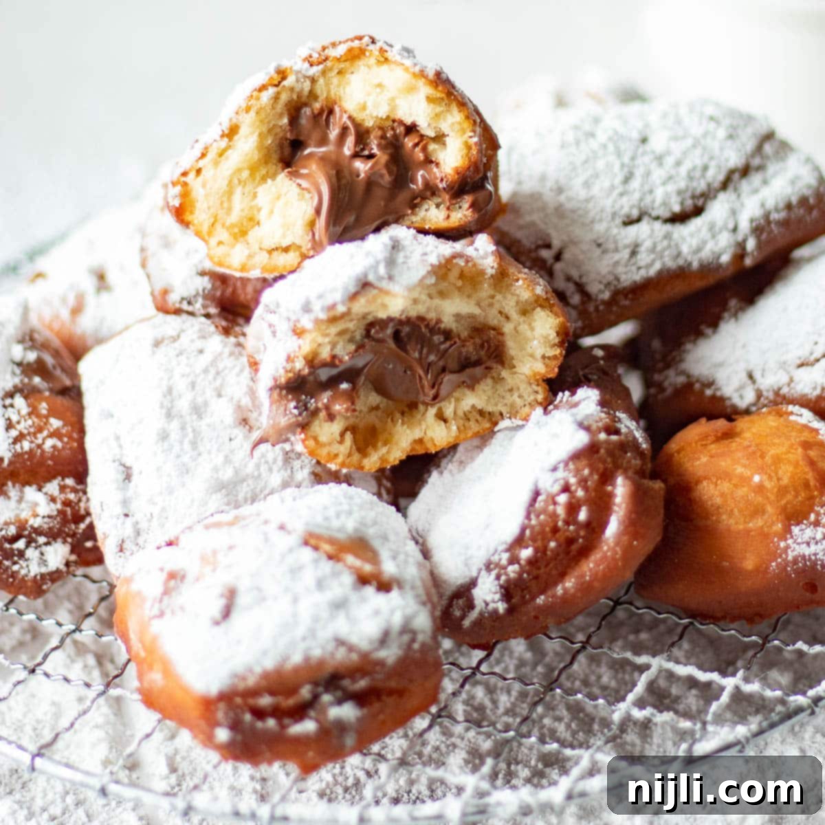 Decadent Chocolate Beignets 19 chocolate beignets on a wire rack