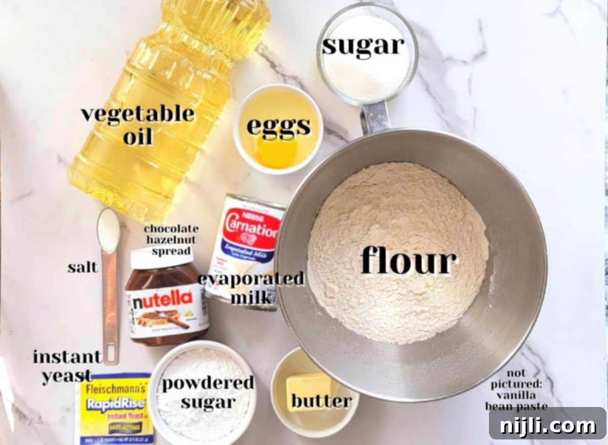 Decadent Chocolate Beignets 6 What are chocolate beignets made of? photo of ingredients including flour, yeast, sugar, salt, egg, evaporated milk, vanilla bean paste, vegetable oil, chocolate hazelnut spread, powdered sugar