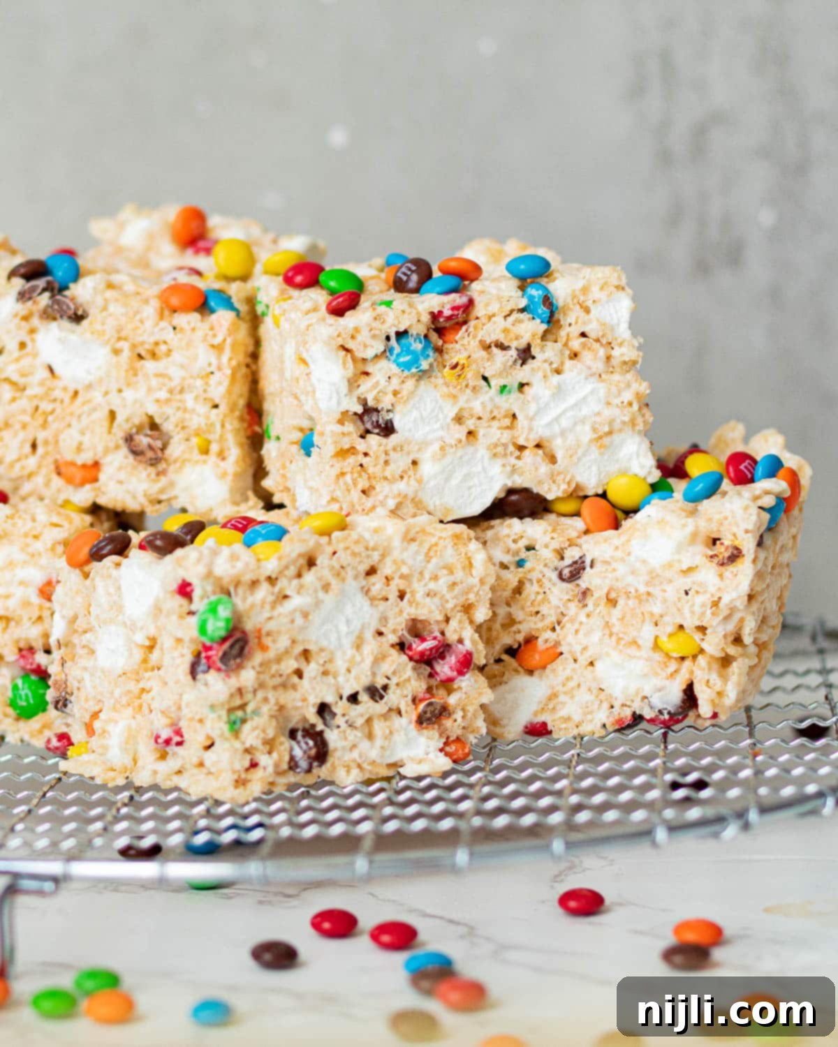 Colorful M and M Rice Krispie Treats 4 chocolate m&m rice krispie treats on a wire rack
