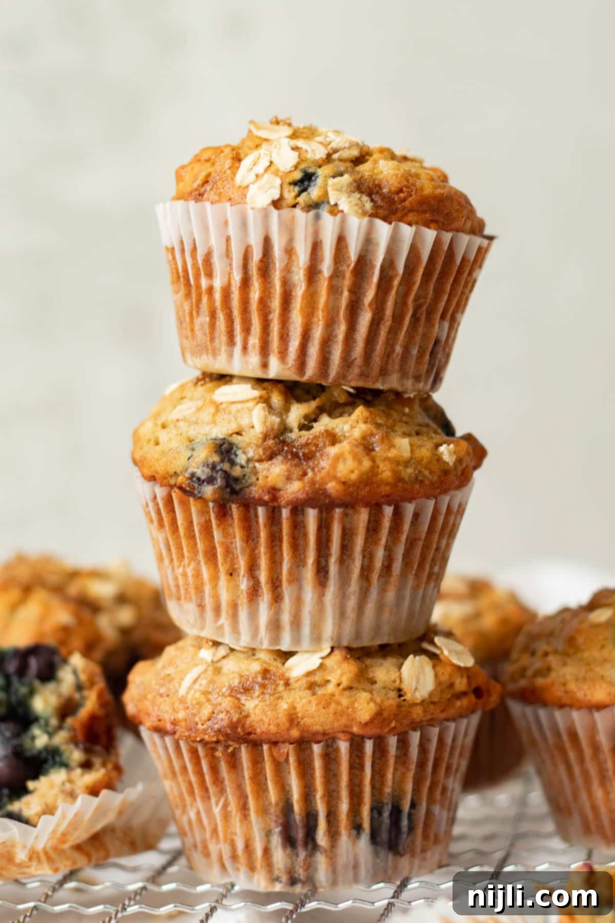toddler eating a banana blueberry oatmeal muffin