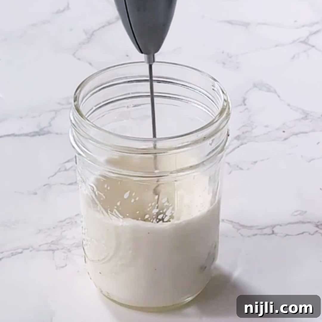 Homemade Sweet Cream Cold Foam 7 Step 2: Using a handheld electric frother to blend the milk mixture
