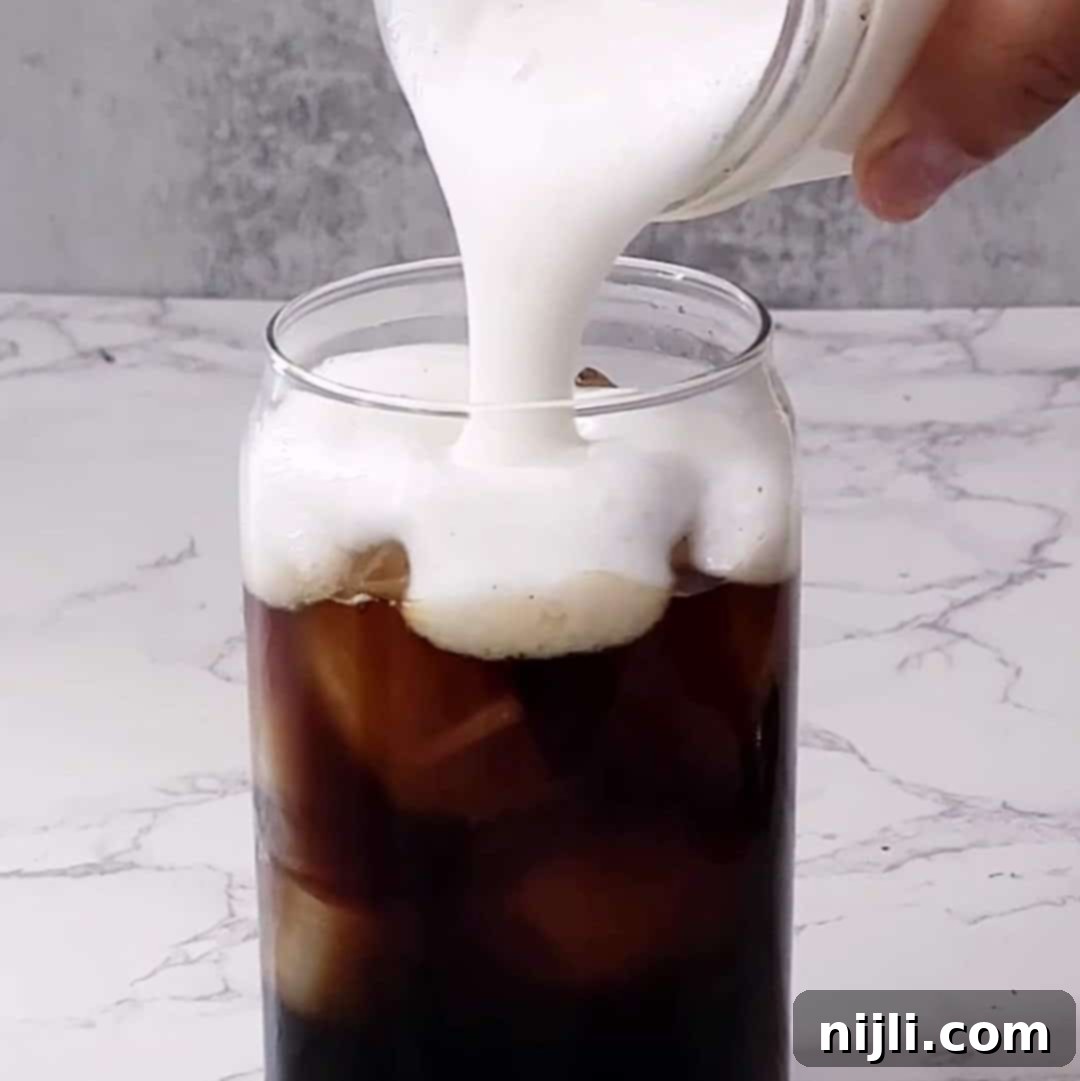 Homemade Sweet Cream Cold Foam 9 Step 4: Pouring the finished cold foam over an iced coffee