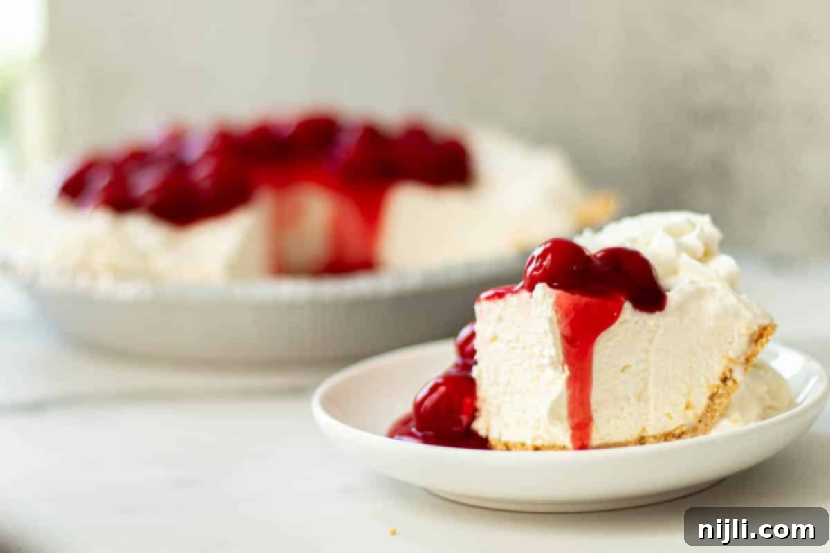 A quick cheesecake with cool whip, garnished with fresh berries and chocolate shavings.
